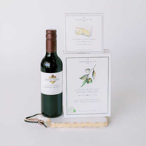 Wine, cheese, and crackers gift basket on marble board gift basket for closing gift