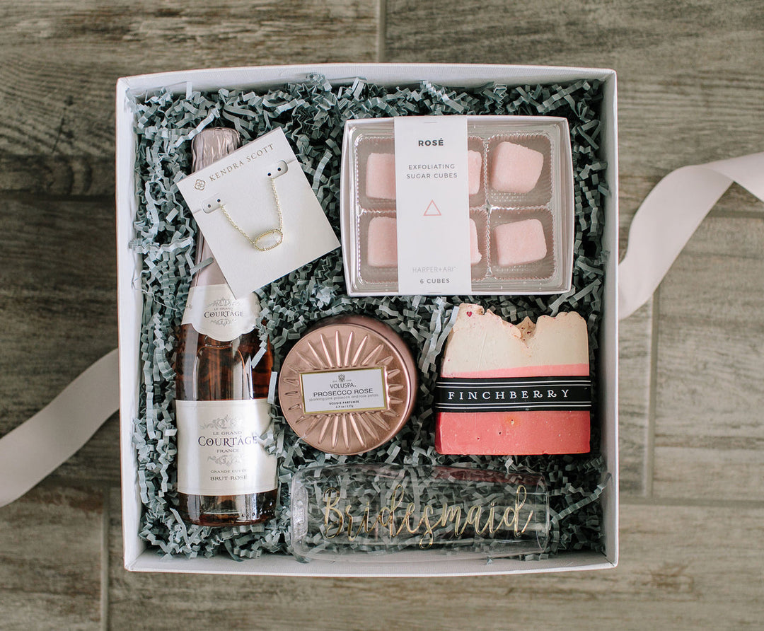 gift box with champagne, bath salts, soap and candle