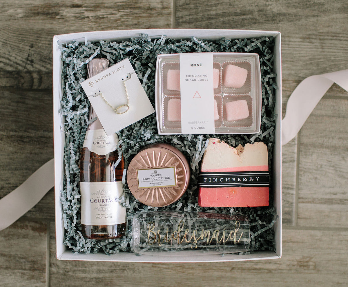 gift box with champagne, bath salts, soap and candle