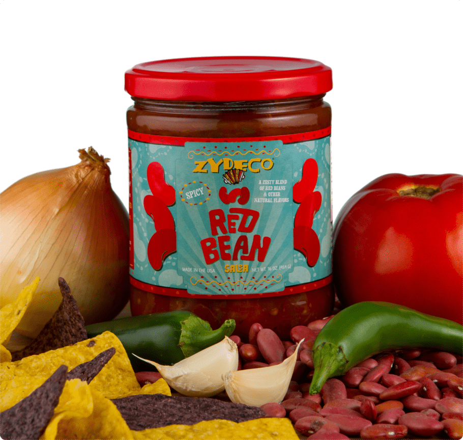 Jar of Zydeco spicy Red Bean salsa surrounded by onion, tomato, peppers, garlic, tortilla chips and red beans
