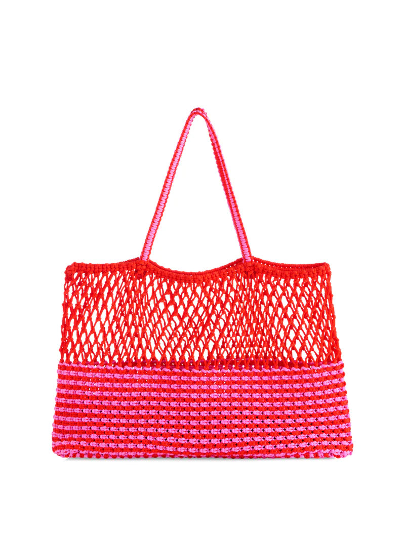Hand-crocheted cotton tote bag centered on a white studio background featuring a vibrant red open-mesh top and a bold pink and red striped lower panel with thin braided handles