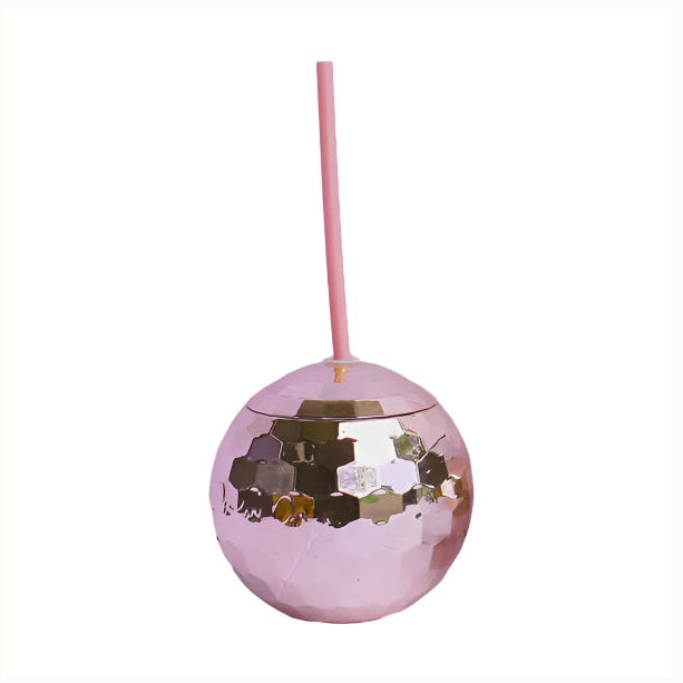 Product photograph of a metallic pink disco ball tumbler with a straw isolated on a white background featuring reflective hexagonal facets and a matching long pink sipping straw