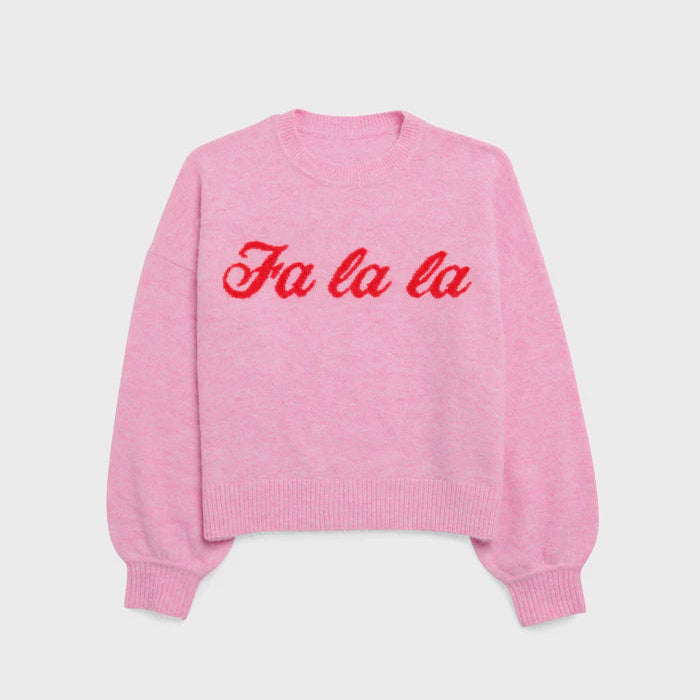 Product photography of a bubblegum pink knit sweater featuring vibrant red cursive Fa la la embroidery with ribbed trim and soft balloon sleeves centered against a neutral grey background