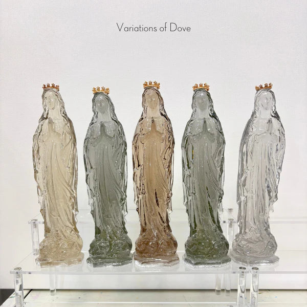 Translucent glass sculptures by Variations of Dove of five Our Lady of Fatima figurines on a clear acrylic display stand, each adorned with a miniature gold crown and tinted in subtle shades of smoky grey, amber, and champagne beige