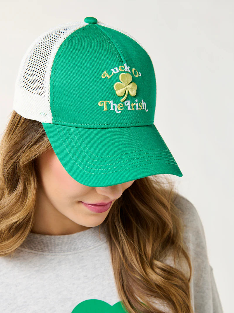 Studio photograph of a woman wearing a green St. Patrick&
