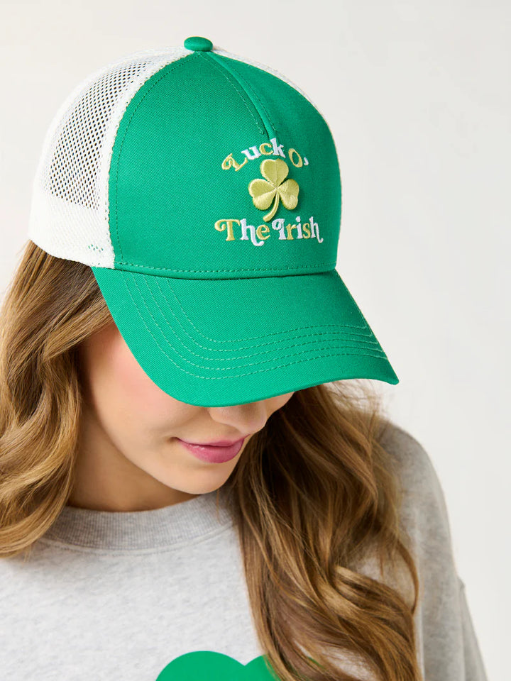 Studio photograph of a woman wearing a green St. Patrick&