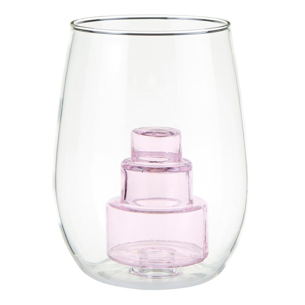 Hand-blown glass stemless wine glass featuring a three-tiered pink translucent cake sculpture inside a curved clear vessel against a white studio background