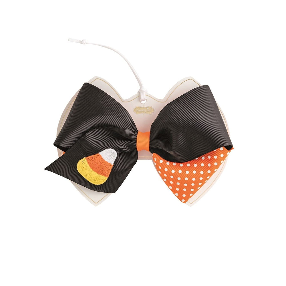 Black grosgrain hair bow with an embroidered candy corn and an orange polka dot tail