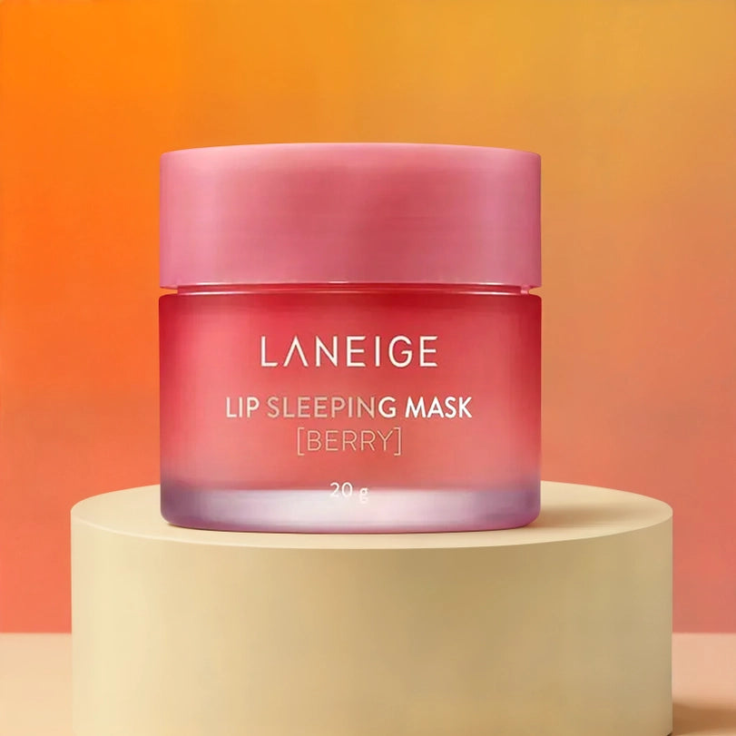 Commercial product photograph of Laneige featuring the Berry Lip Sleeping Mask on a cream pedestal against a warm orange gradient backdrop showcasing a pink frosted glass jar and white lettering