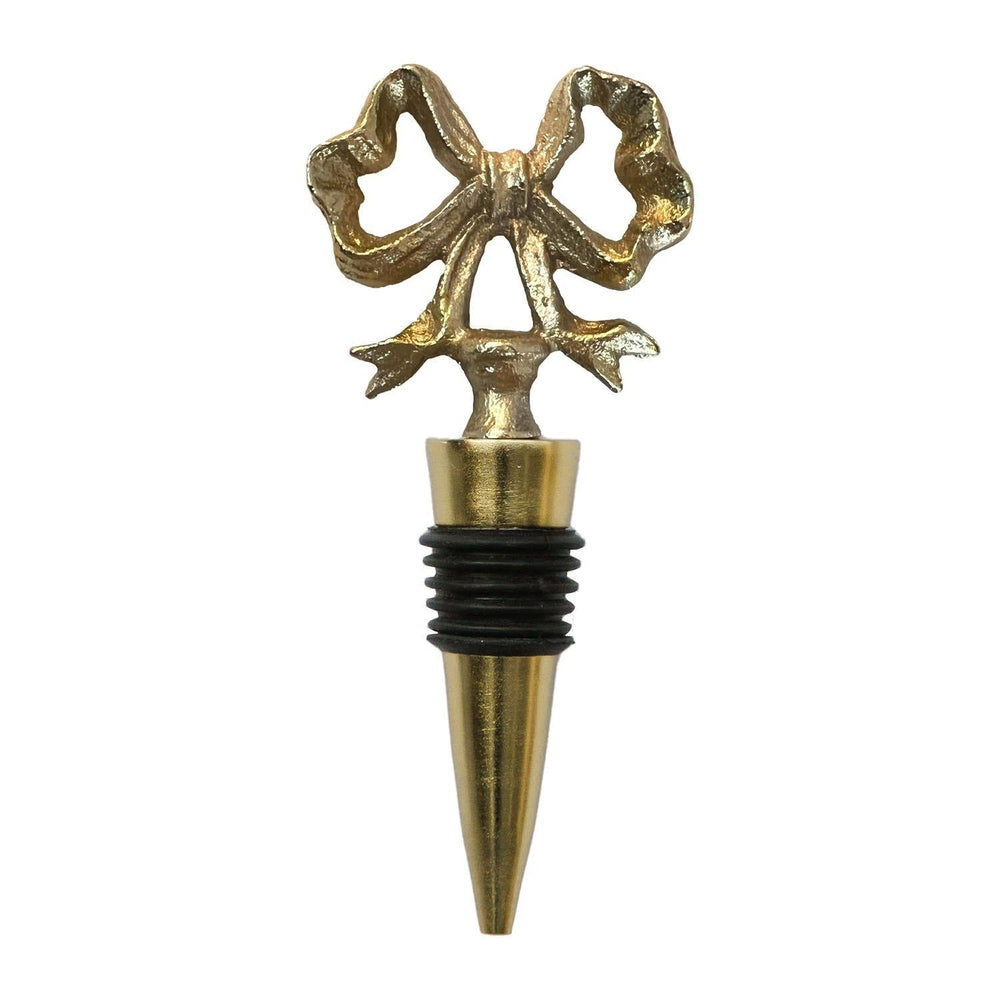 Cast metal wine bottle stopper on a white background featuring a textured gold-finished ribbon bow topper, a polished tapered base, and a black rubber gasket seal