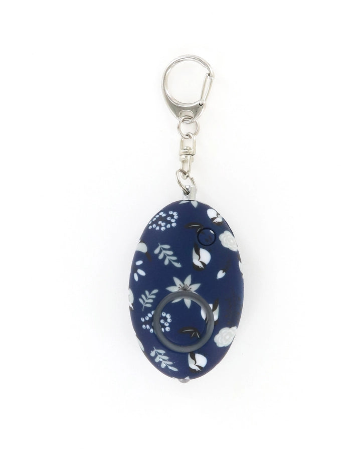 Navy egg-shaped alarm keychain with white floral print