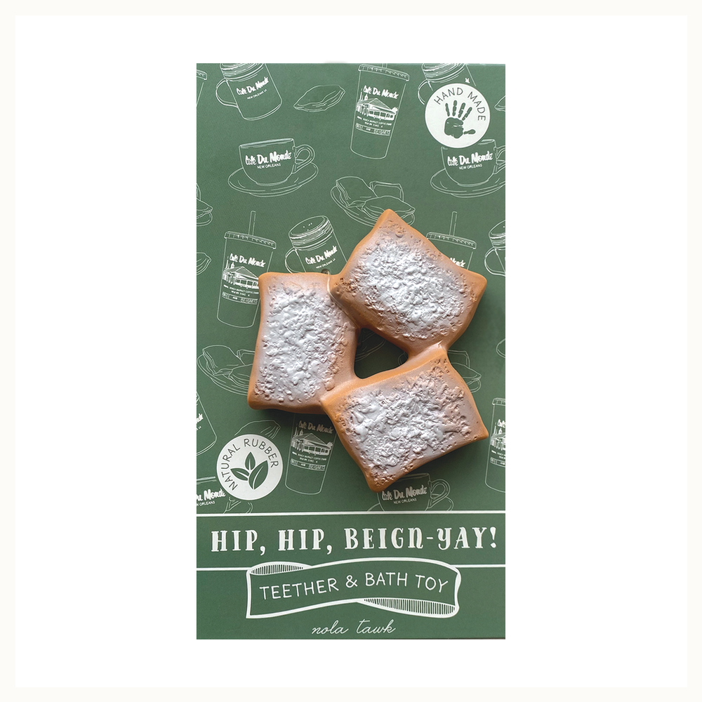 Natural rubber teether by nola tawk featuring three realistic golden-brown beignets from Cafe Du Monde in New Orleans with textured white powdered sugar on a green background with white line art and the phrase HIP, HIP, BEIGN-YAY