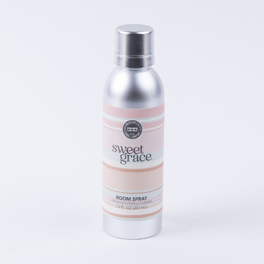 Commercial photograph of a Bridgewater Candle Company Sweet Grace Room Spray bottle on a white background featuring a brushed silver aluminum canister with a soft pink and peach striped label and the signature brand logo