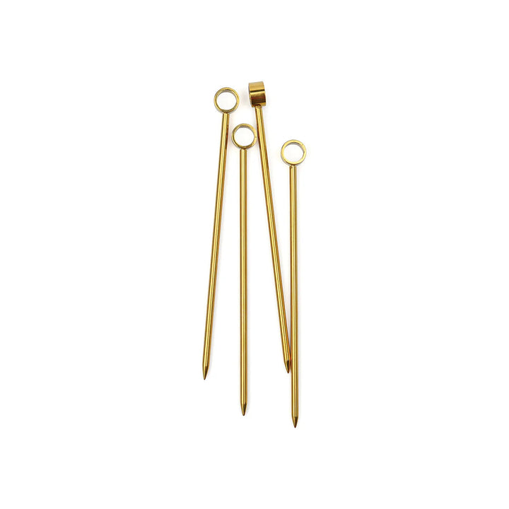 Four gold cocktail picks with ring tops