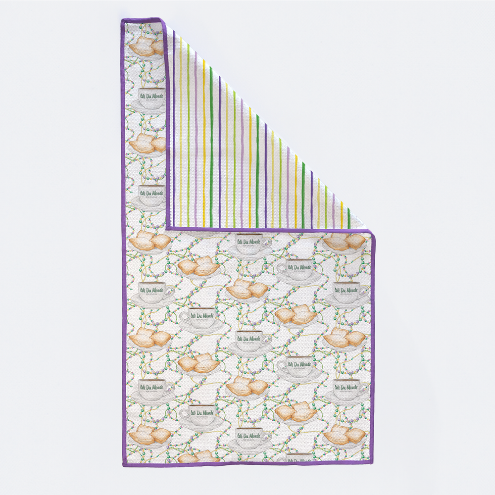 Beignet print kitchen towel with corner folded to show striped reverse side