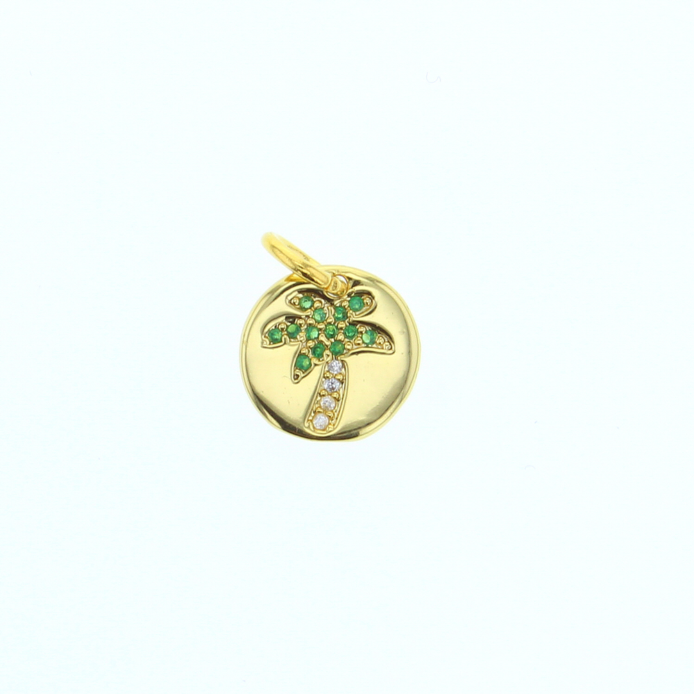 Gold jewelry pendant featuring a circular disk with a tropical palm tree design decorated with vibrant green gemstones and sparkling clear crystals centered on a white background