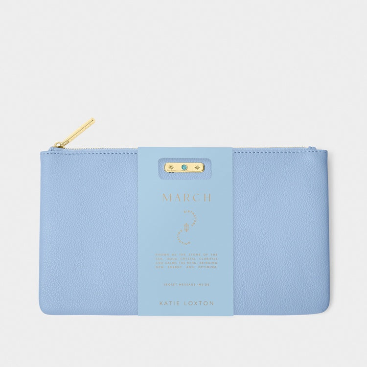Pebble-textured vegan leather pouch by Katie Loxton featuring the March Birthstone collection in cornflower blue with a gold-tone zipper and a small turquoise crystal accent on the decorative band