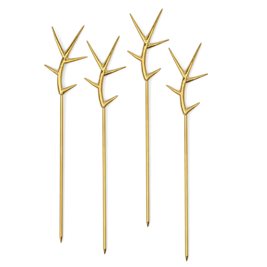 Four long gold cocktail picks with branching antler-shaped tops