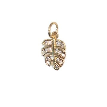 Gold-toned jewelry pendant featuring a tropical leaf design encrusted with sparkling clear stones and a polished jump ring against a plain white background