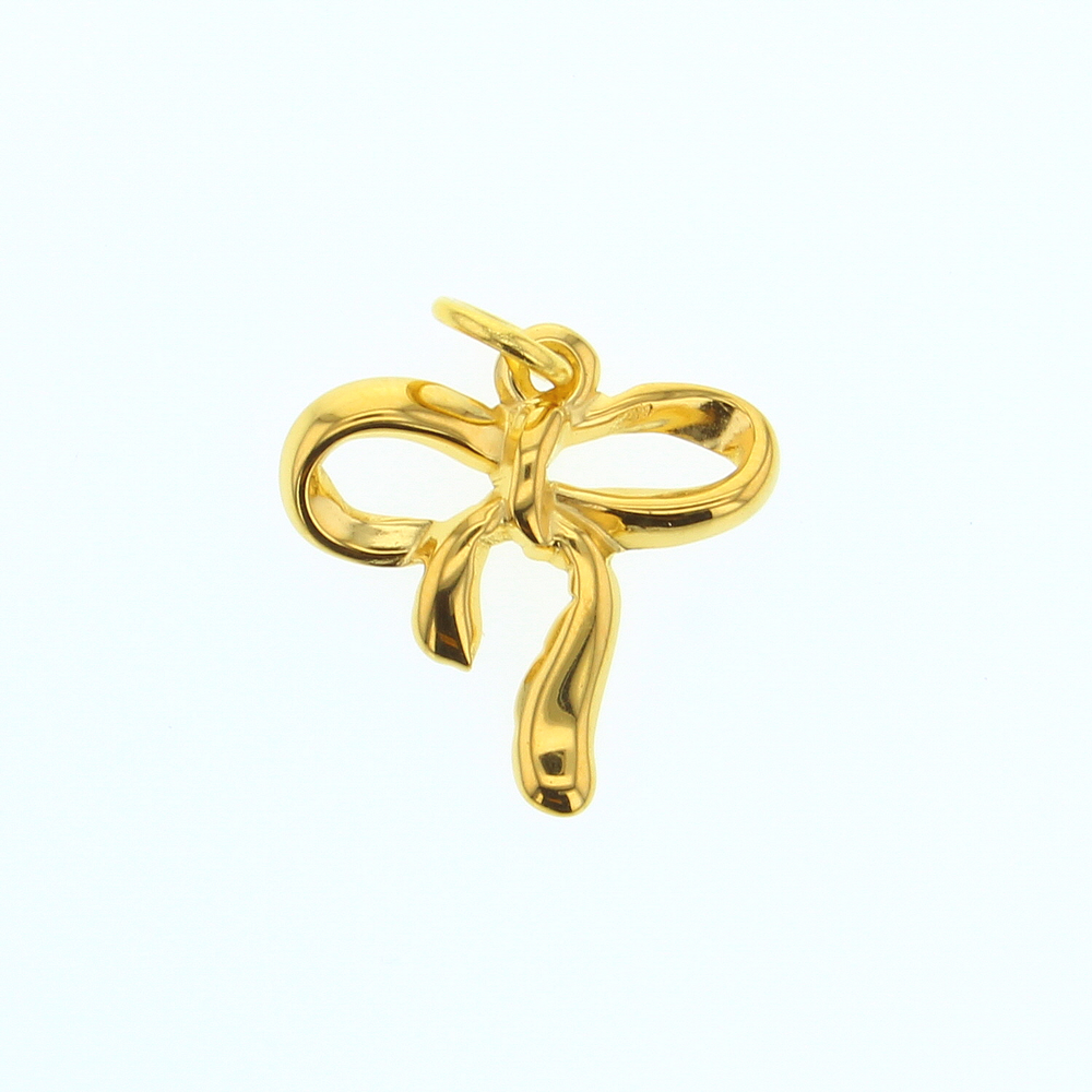18k yellow gold pendant by Tiffany & Co featuring a delicate ribbon bow charm with a high-polish finish and fluid knotted structure centered against a minimalist white background