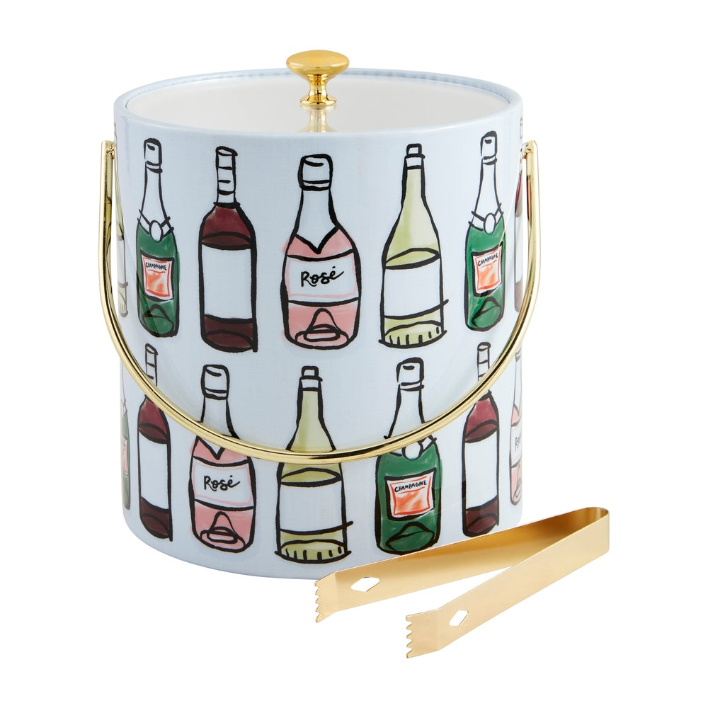 Kate Spade New York illustrated ice bucket on a white background featuring a whimsical pattern of colorful champagne and rosé bottles with a polished gold-tone handle and matching gold ice tongs