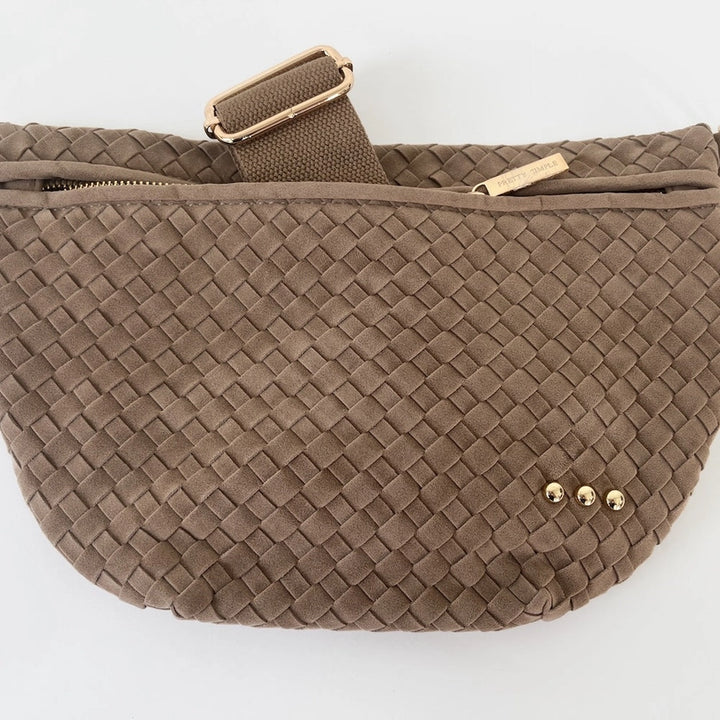Pretty Simple woven faux suede belt bag in taupe showcases a textured intrecciato pattern, gold-tone hardware including three small decorative studs, and a branded zipper pull on a white background
