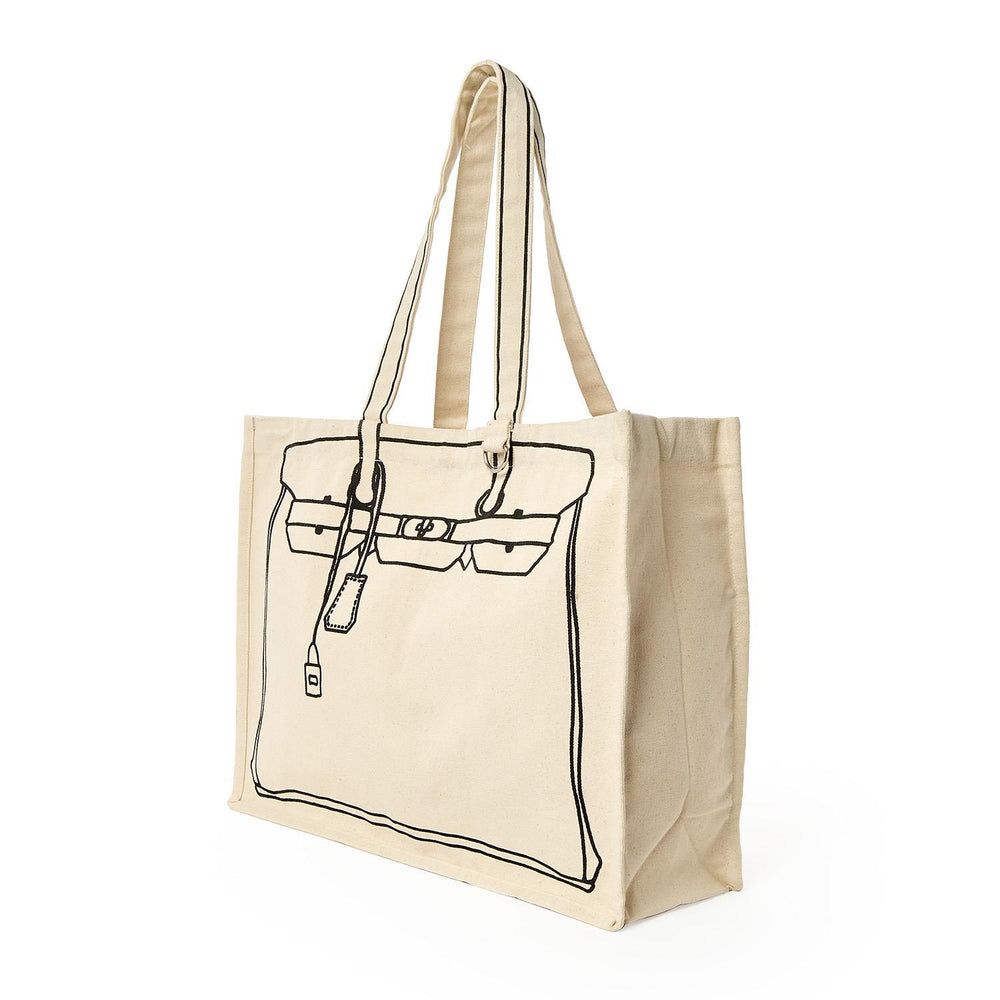 Canvas tote bag by Thursday Friday featuring a black line-art illustration of an iconic designer handbag silhouette with trompe l'oeil details including a hanging clochette and belt straps on a plain white background