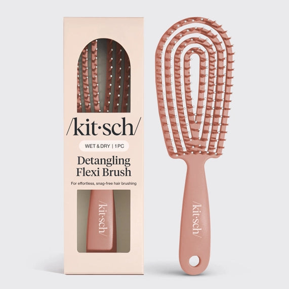 Product photography by Kitsch featuring a mauve Detangling Flexi Brush and its branded box in a studio setting, highlighting the flexible spiral vented head, white-tipped bristles, and bold minimalist typography