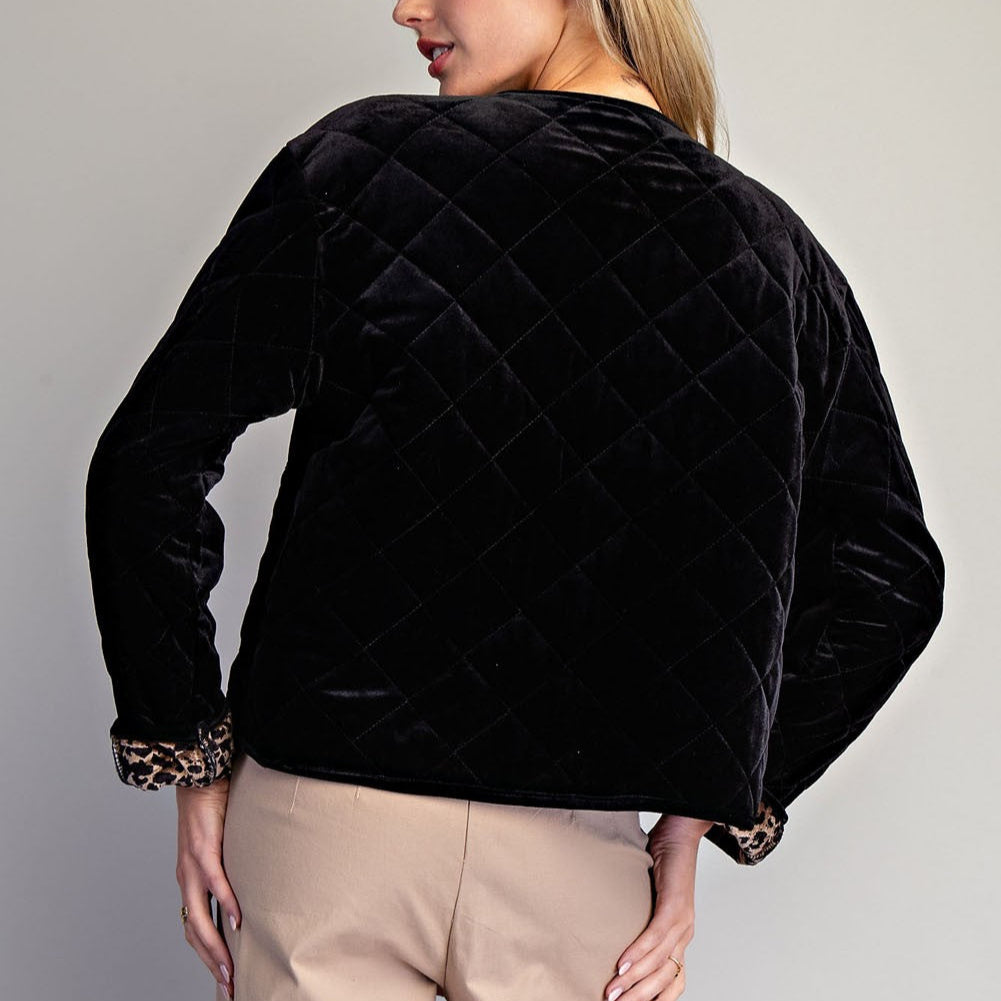 Back view of a black quilted velvet jacket with leopard-print cuffs