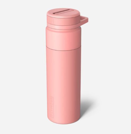 Studio photograph of a BrüMate reusable water bottle in a soft matte pink finish featuring a flip-top lid with an integrated carry loop and vertical embossed branding against a plain white background