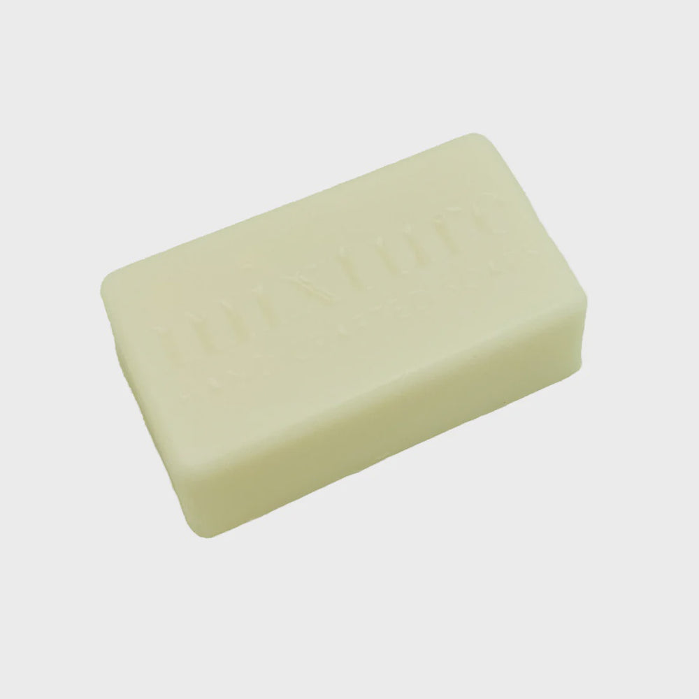Handcrafted bar soap by Mixture featuring a rectangular cream-colored bar with an embossed brand logo and smooth matte texture against a neutral background