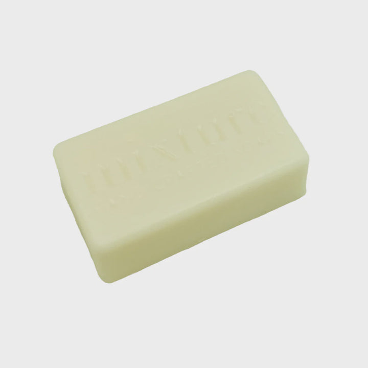 Unwrapped cream bar of soap embossed mixture