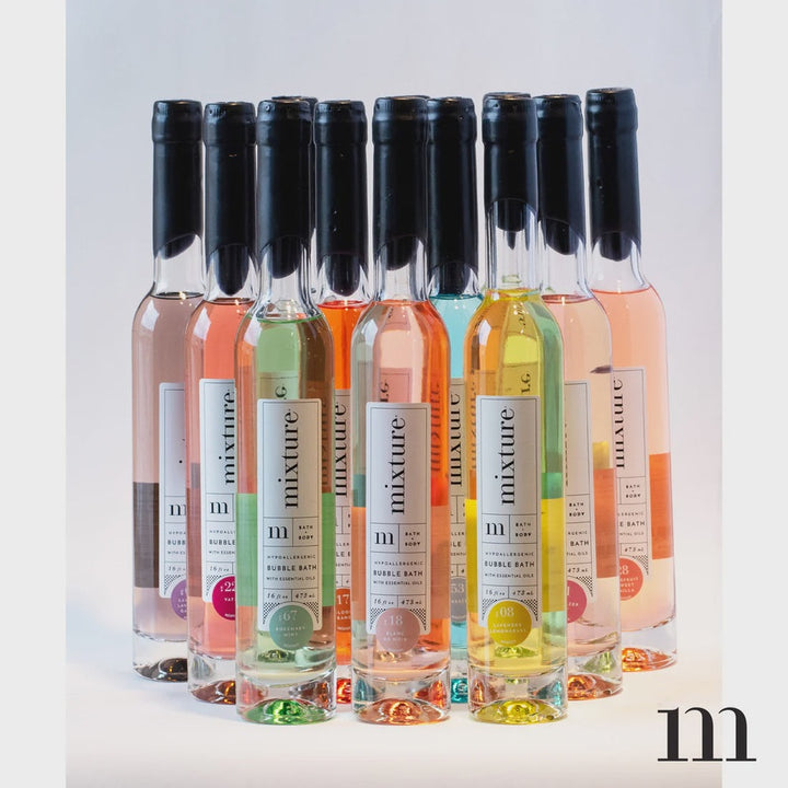 Group of Mixture bubble bath bottles with black wax tops in pink, peach, green, yellow and blue