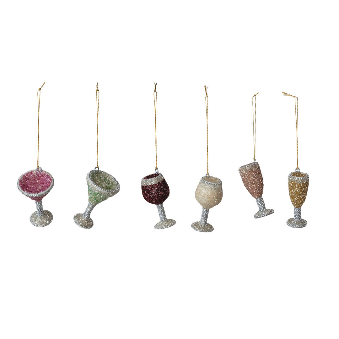 Beaded glass ornaments of six festive cocktail and wine glass charms displayed against a neutral white background featuring vibrant seed beads, intricate silver-pearl stems, and delicate gold hanging cords