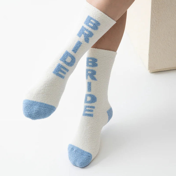Product photograph of fuzzy white crew socks worn on a person&