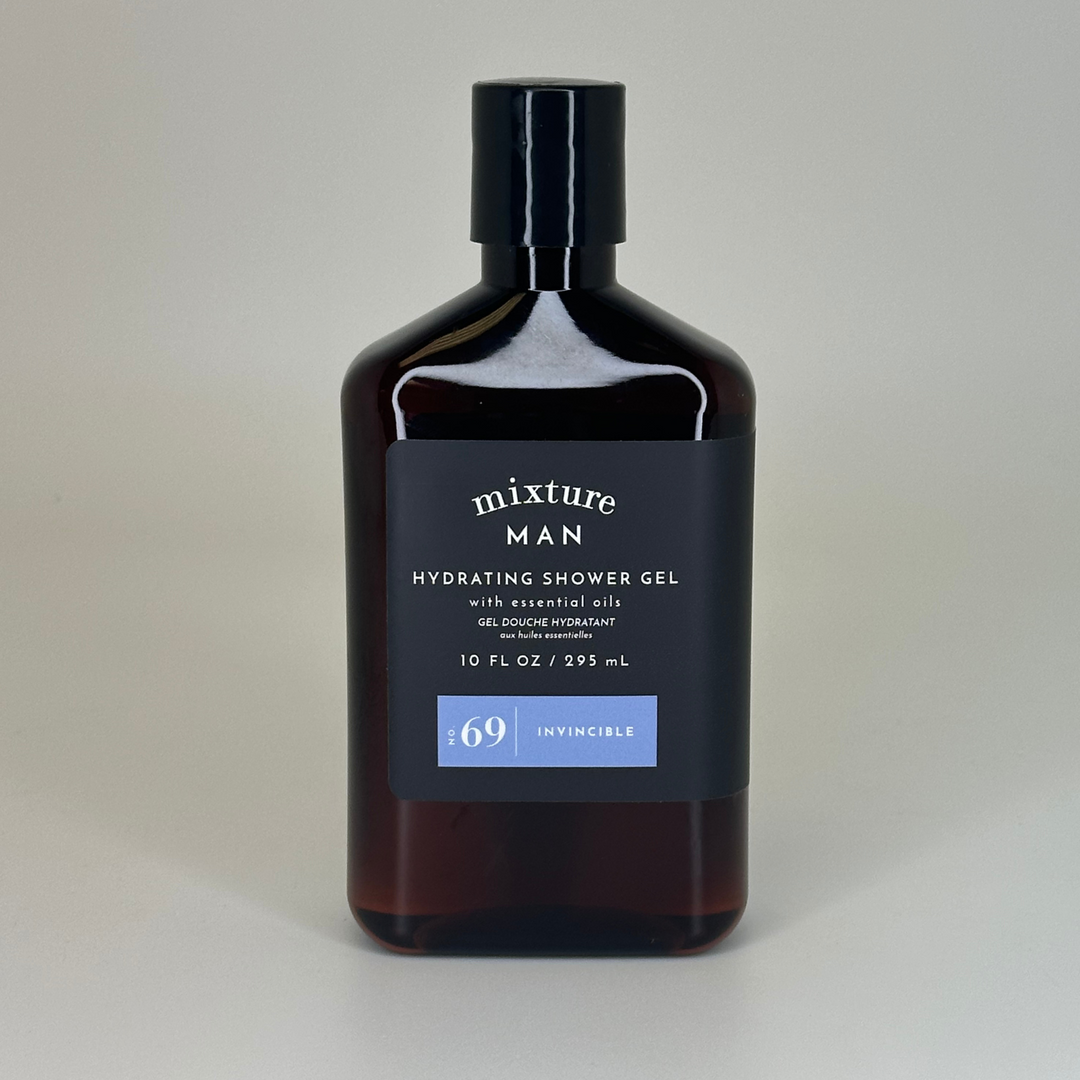Studio photograph of Mixture MAN Hydrating Shower Gel on a neutral background featuring a dark amber translucent bottle with a matte black cap and a light blue No. 69 Invincible label badge