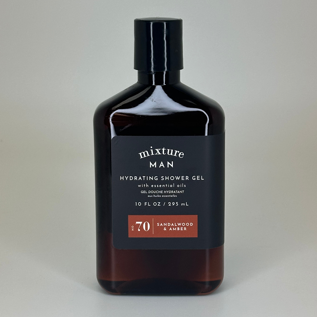 Product photograph by Mixture featuring a bottle of Sandalwood &amp; Amber hydrating shower gel in a neutral studio setting, highlighting the dark amber-tinted container, a matte black label with white typography, and a prominent reddish-brown No 70 graphic element