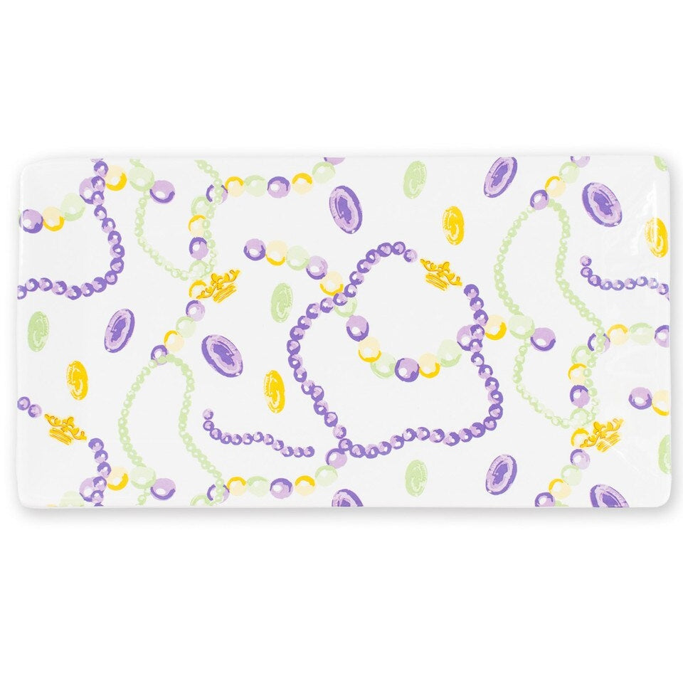 White rectangular platter printed with purple, green and gold Mardi Gras beads, doubloons and crowns