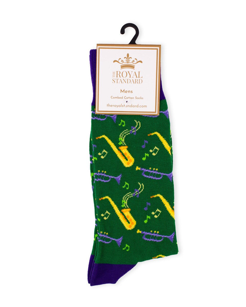 Men's green socks with gold saxophones, purple trumpets and music notes on a Royal Standard hanger card