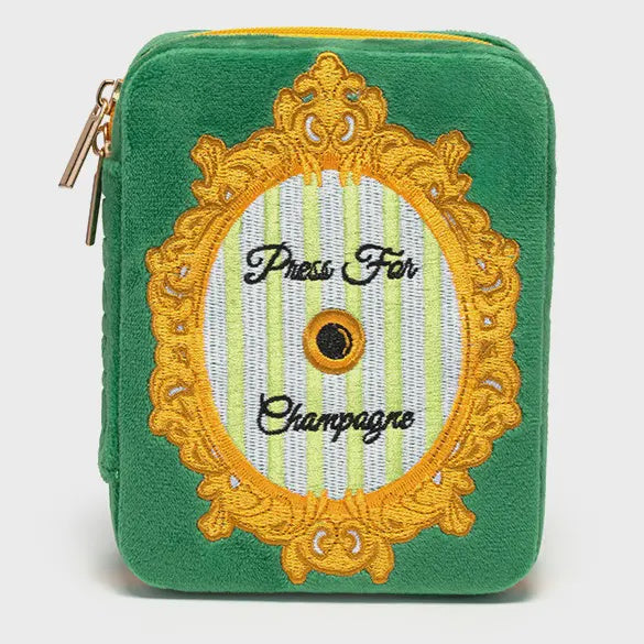 Embroidered green velvet travel case featuring the iconic Press For Champagne button design within an ornate gold filigree frame and mint green stripes set against a white background