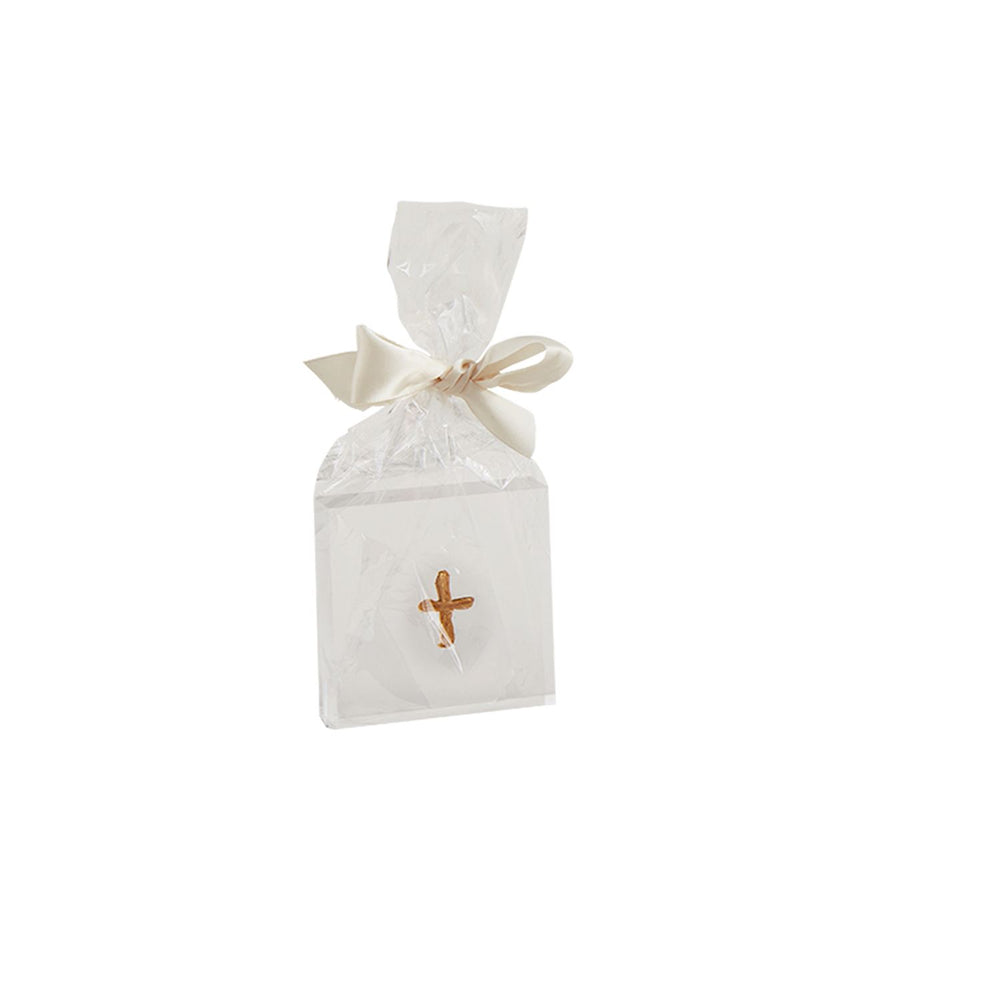 Handcrafted religious gift favor featuring a white square box with a small golden cross wrapped in clear cellophane and finished with a cream satin ribbon bow against a plain white background