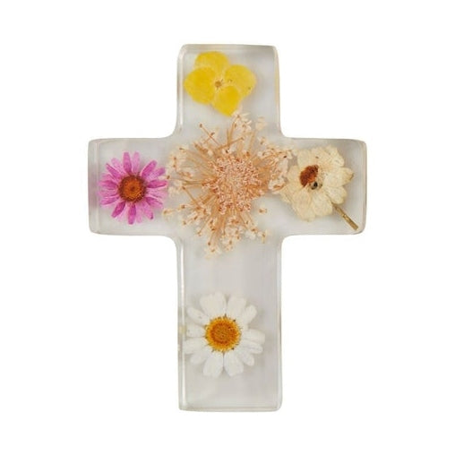 Clear resin religious cross featuring vibrant pressed dried flowers including a pink daisy, a central peach-colored blossom, and a white wildflower against a plain white background