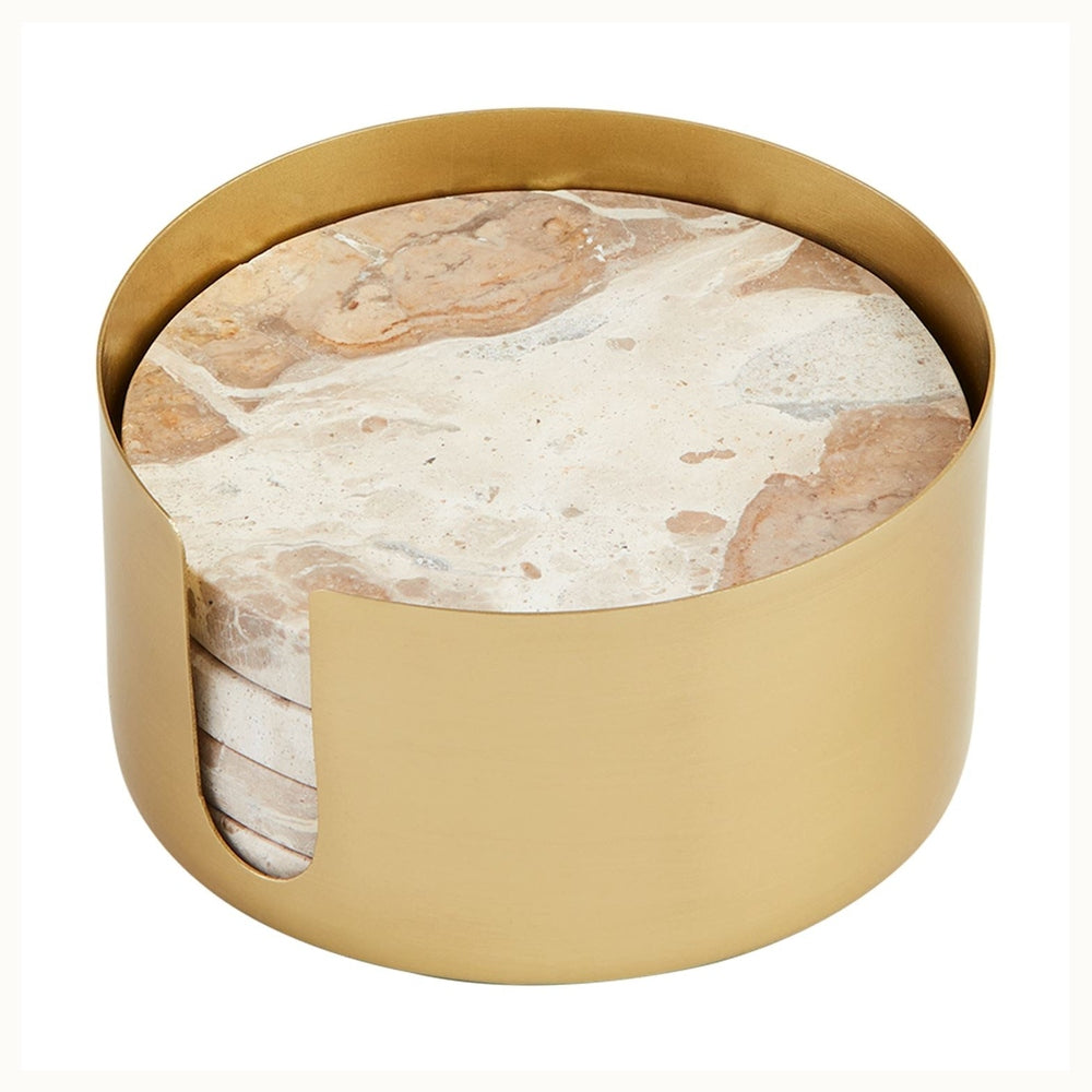 Natural marble and brushed gold metal coaster set features round stone discs with earthy tan veining stacked inside a matte brass-finished cylindrical holder with a side access cutout on a white background