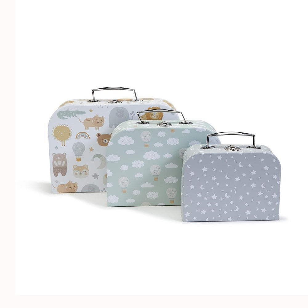 Product photograph of three decorative nesting storage suitcases in varying sizes featuring safari animal illustrations, whimsical hot air balloons, and a celestial star and moon pattern with silver metal handles