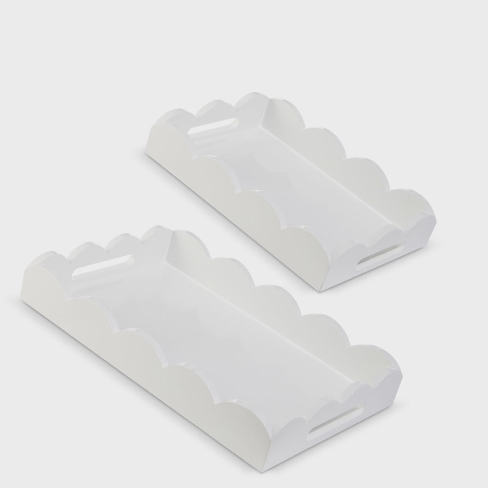 Painted wood rectangular serving trays on a neutral studio background featuring decorative scalloped edges and integrated cutout handles