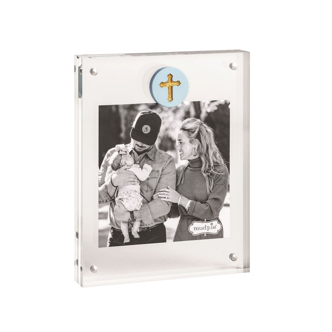 Mud Pie acrylic magnetic block frame showcasing a black and white family portrait featuring a light blue circular medallion with a gold-textured cross and four polished silver magnetic corner fasteners