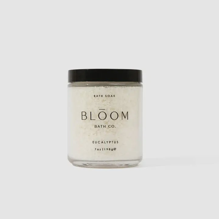 Bloom Bath Co. Eucalyptus bath soak in a glass jar with a black lid