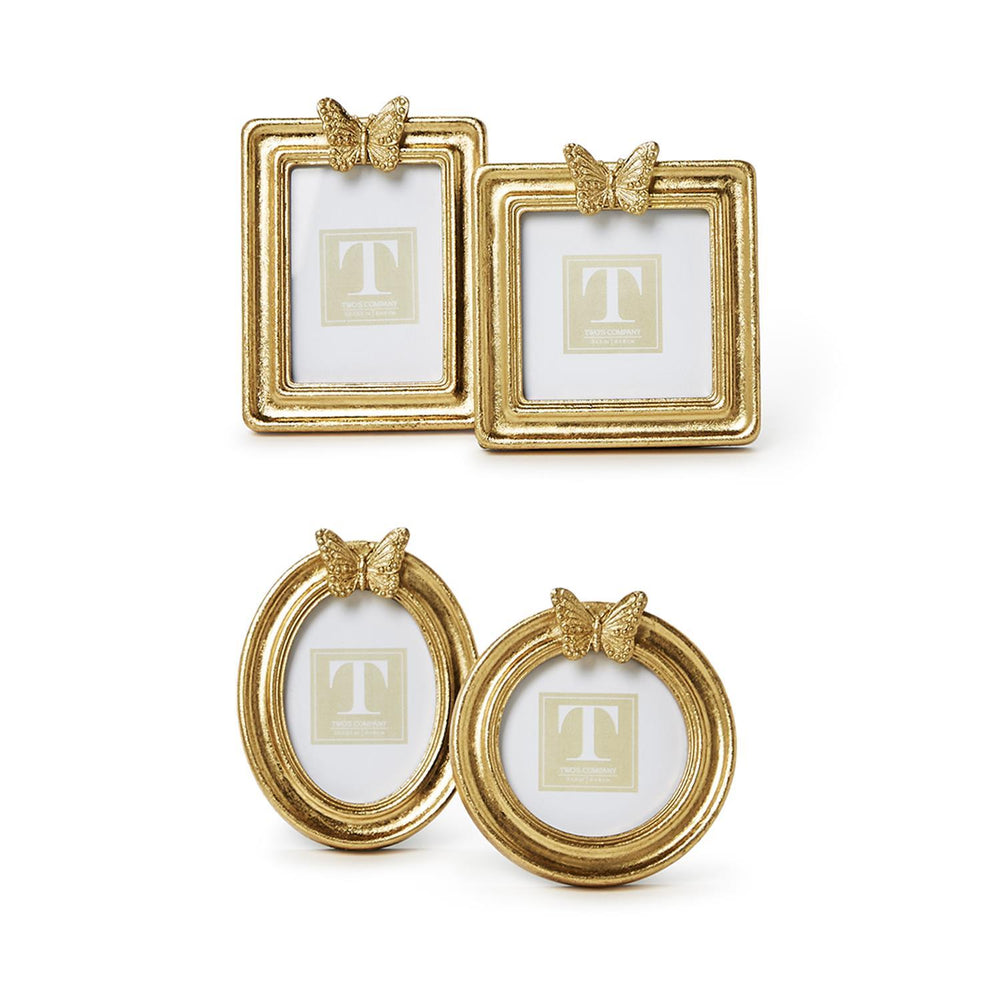 Gold-finished decorative frames by Two's Company featuring four butterfly-topped photo holders in square, rectangular, oval, and round shapes with a textured metallic patina on a white background