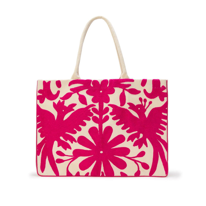 Embroidered canvas tote bag in the traditional Mexican Otomi style featuring a vibrant fuchsia pink Tenango pattern of symmetrical birds and a large central flower on a cream background