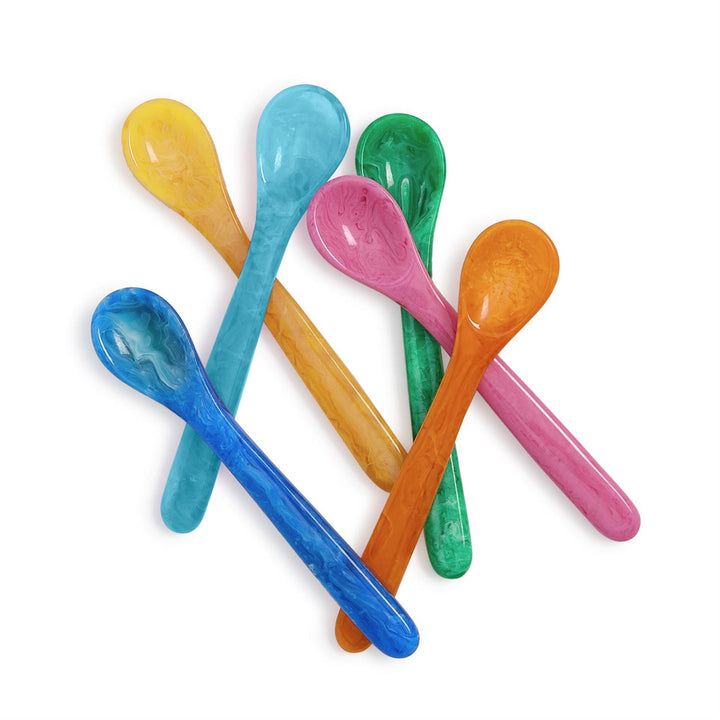 Marbled resin spoons arranged in a scattered cluster on a white background featuring vibrant shades of teal, pink, and orange with intricate swirling patterns and a polished glossy finish